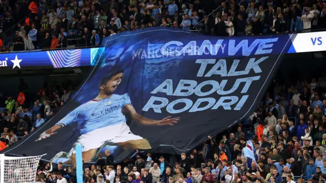 A banner at Etihad stadium that reads 'Can we talk about Rodri'