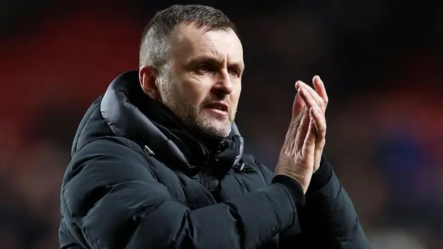 Charlton boss Nathan Jones applauds the Addicks fans after their goalless draw with QPR at The Valley