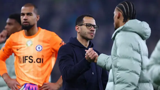 Liam Rosenior shakes hands with Joao Pedro with Robert Sanchez in the background