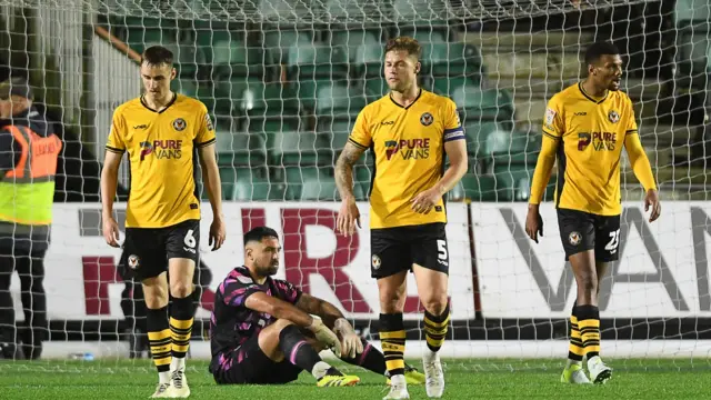 Newport County players looking dejected after conceding 2 goals in quick succession