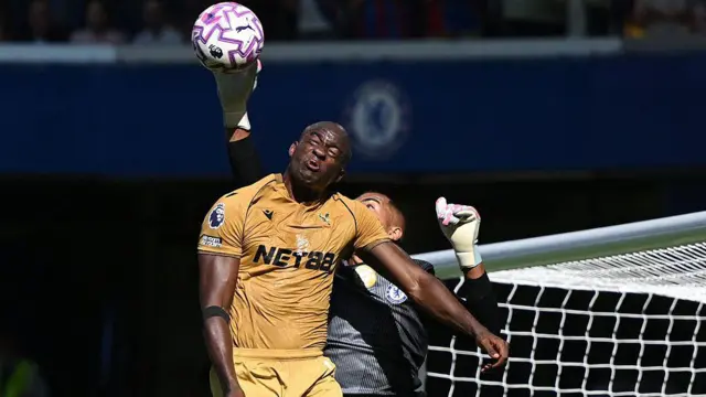 Chelsea's Spanish goalkeeper #01 Robert Sanchez (R) rises to paw the ball away from Crystal Palace's French striker #14 Jean-Philippe Mateta (L) during the English Premier League football match between Chelsea and Crystal Palace at Stamford Bridge 
