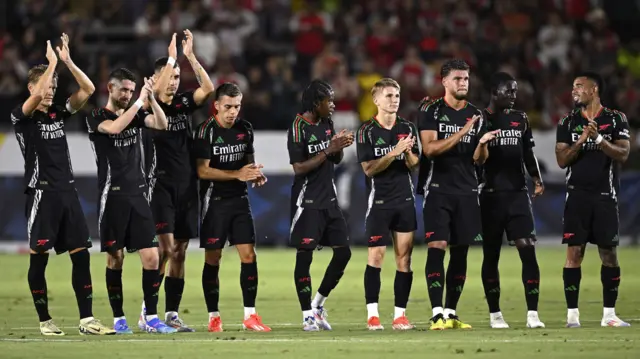 Arsenal players applaud during a penalty shootout