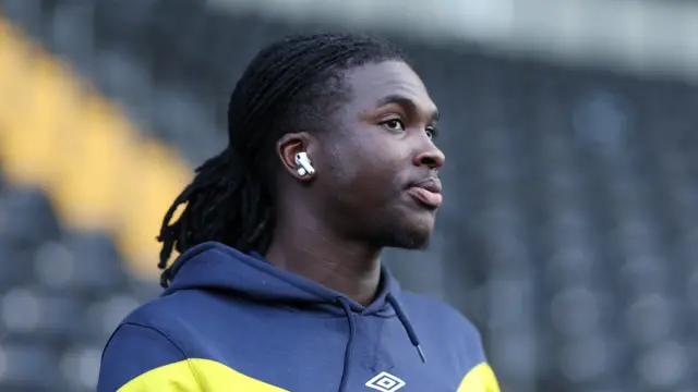 Osman Foyo walking on a pitch during pre-game for AFC Wimbledon last season