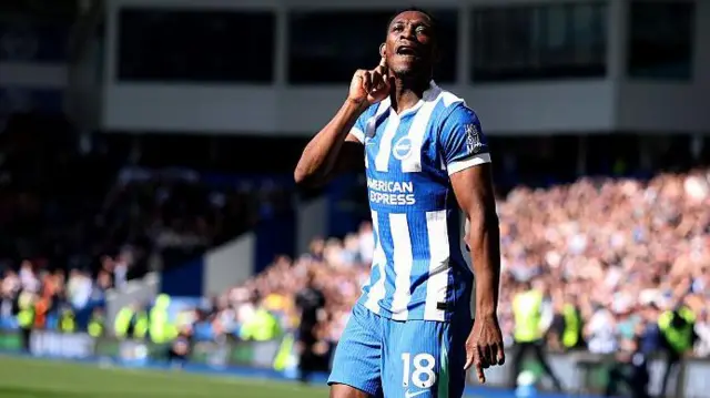 Danny Welbeck putting his finger to his ear as a gesture towards the crowd during a Brighton match