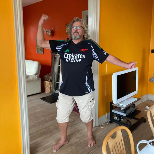 Arsenal fan posing in an Arsenal kit