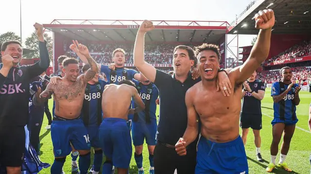 Head coach Andoni Iraola and James Hill of Bournemouth after the 1-1 draw at Nottingham Forest, with other players celebrating close by