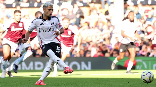 Fulham's Andreas Pereira side-foots a penalty kick against Aston Villa