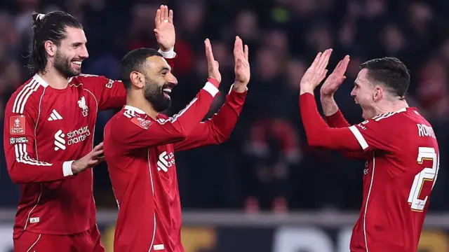 Salah, Szobozslai and Robertson celebrate a Liverpool goal