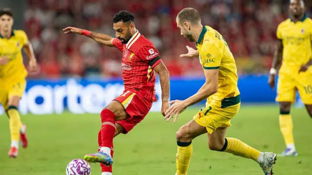 Mohamed Salah of Liverpool (L) and Matteo Pittarella of AC Milan (R)