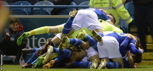 Carlisle United's players celebrate their dramatic late winner against Exeter City