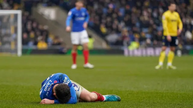 Portsmouth's Callum Lang on the grass during their match against Oxford United