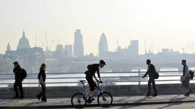 Man cycling across a bridge