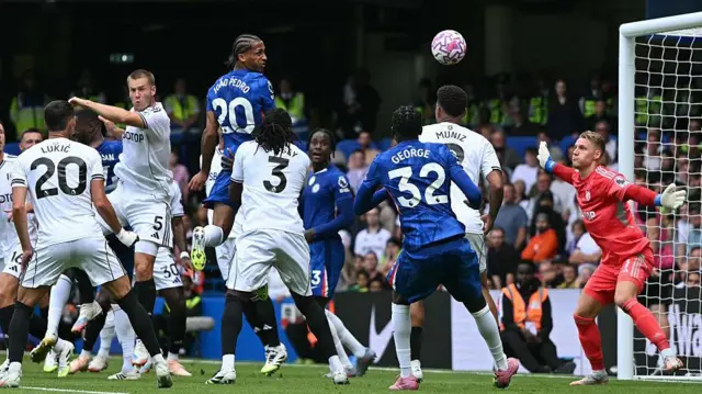  Joao Pedro scoring a header against Fulham goalkeeper Bernd Leno