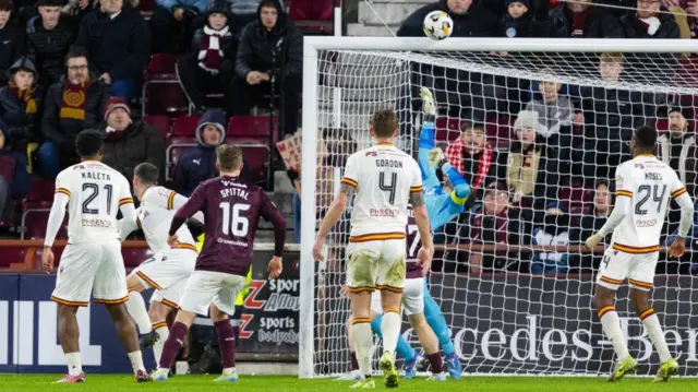 Hearts' Craig Gordon tips a shot from Motherwell's Jack Vale (L) over the bar during a William Hill Premiership match between Heart of Midlothian and Motherwell at Tynecastle Park,
