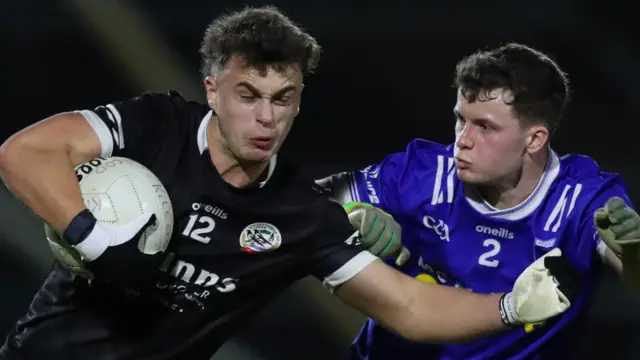 Kilcoo forward Shealan Johnston is challenged by Scotstown's Darragh Murray at the Athletic Grounds