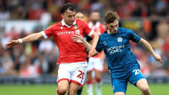 Ollie Rathbone (left) in action against Shrewsbury Town's Tommi O'Reilly 