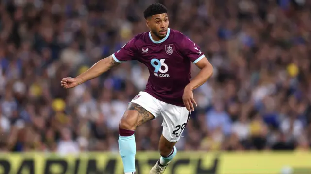Josh Laurent playing for Burnley in their claret home kit in May