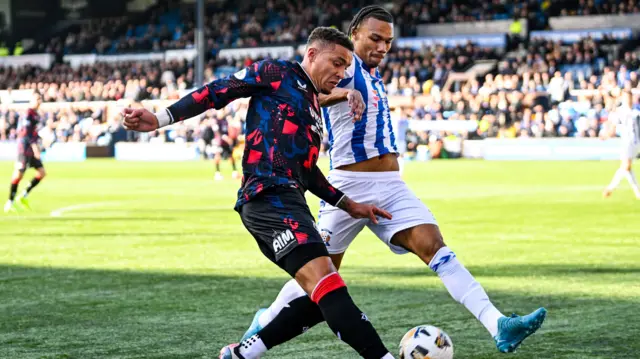 James Tavernier and Corrie Ndaba battle for possession