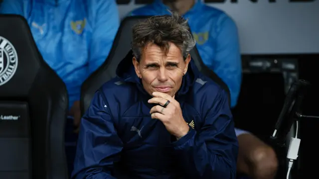 Simo Valakari watches on from the bench, chin in hand