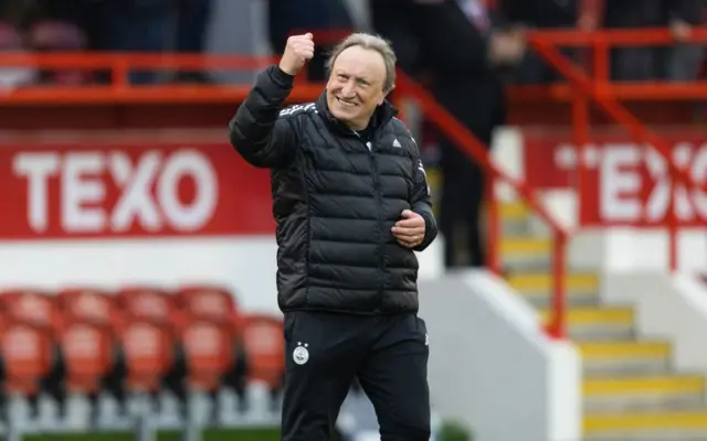 Neil Warnock celebrates Aberdeen's 3-1 victory over Kilmarnock in the Scottish Cup.