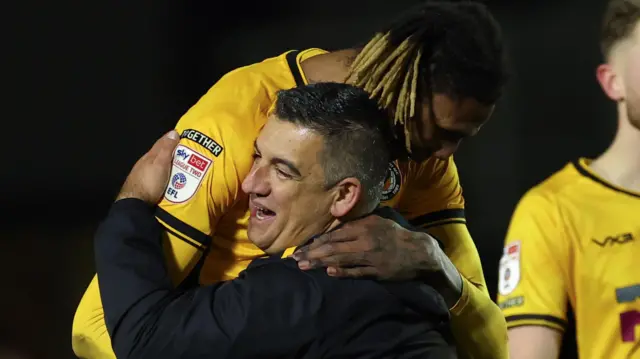 Newport County head coach Nelson Jardim with Kyle Hudlin of Newport County on the final whistle