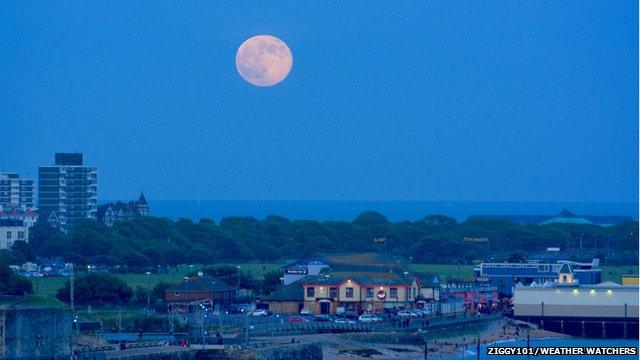 Full moon over a city skyline