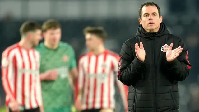 Sunderland head coach Regis Le Bris claps his hands as he leaves the Pride Park pitch in Derby