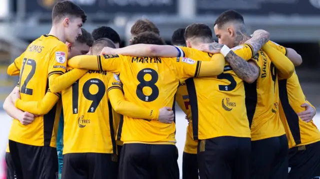 Newport County players in a huddle