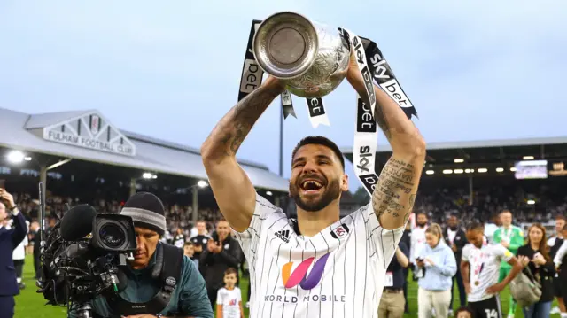 Aleksandar Mitrovic lifts the Championship trophy