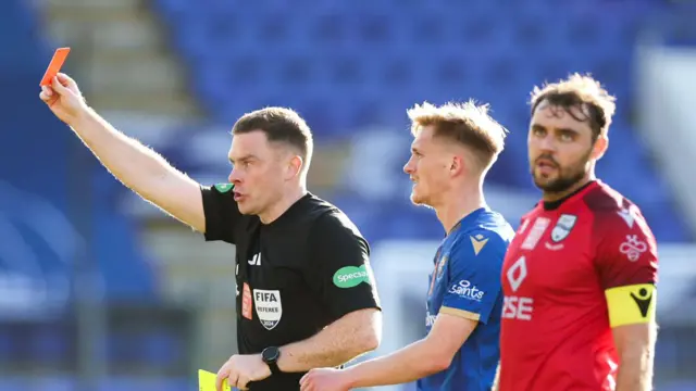 Connor Randall exasperated at John Beaton showing Eli Campbell a red card