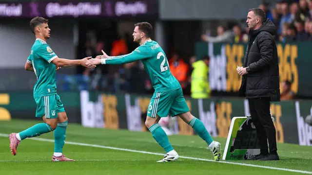 Andy Robertson replaces Milos Kerkez during the first half of Liverpool's game at Burnley