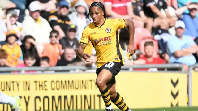 Moses Alexander-Walker runs with the ball for Newport County