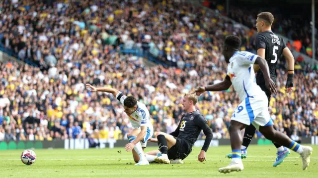 Manor Solomon of Leeds United is challenged by Joe Worrall of Burnley