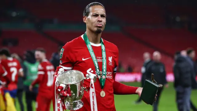 Virgil van Dijk of Liverpool poses for a photo with the Carabao Cup Trophy and his Player Of The Match award during the Carabao Cup Final match between Chelsea and Liverpool at Wembley Stadium