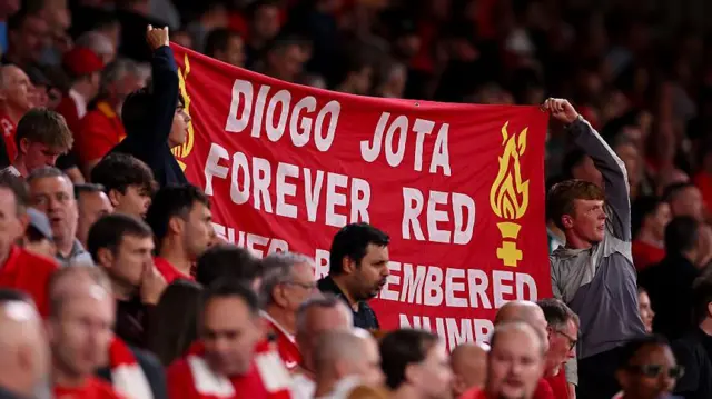 Fans of Liverpool hold up a banner for Diogo Jota at full time during the Premier League match between Liverpool and Bournemouth at Anfield