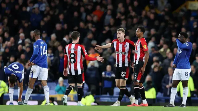 Mathias Jensen, Nathan Collins and Ethan Pinnock of Brentford interact