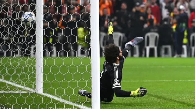 Alisson tries unsuccessfully to save Victor Osimhen's penalty