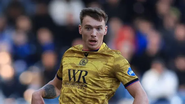 Hayden Carter looking up while in action for Blackburn Rovers.