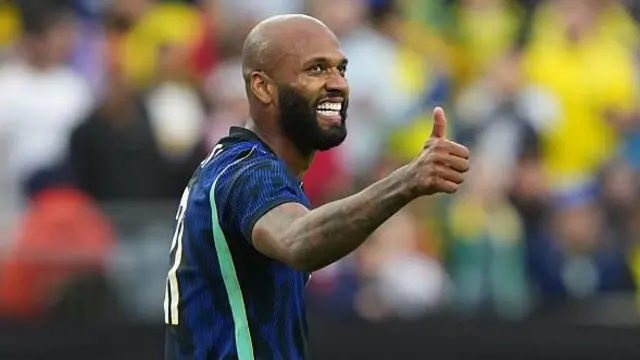 A smiling Igor Thiago with his thumb up during his debut for Brazil