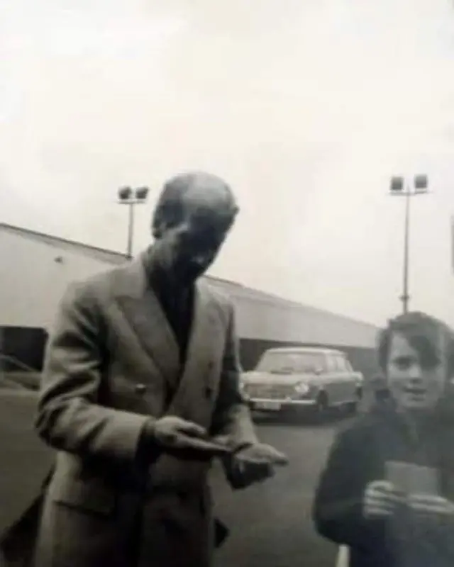 Young Manchester United fan with Bobby Charlton