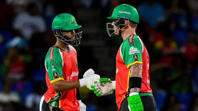Ben McDermott and Shai Hope of Guyana Amazon Warriors punch gloves
