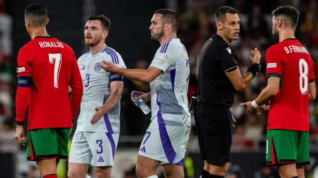 Portugal's Ronaldo with Scotland's Andy Robertson and John McGinn