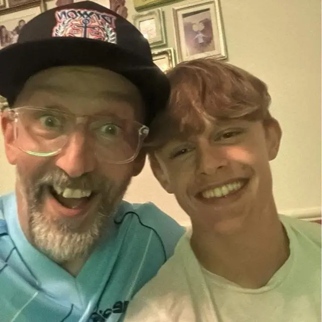 Two Tottenham fans smiling at the camera