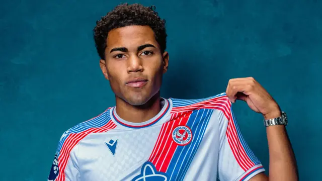 Zavier Gozo poses for a photo in Crystal Palace's 2026-27 home kit
