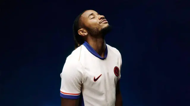 CHristopher Nkunku modelling the new Chelsea 2024-25 away kit