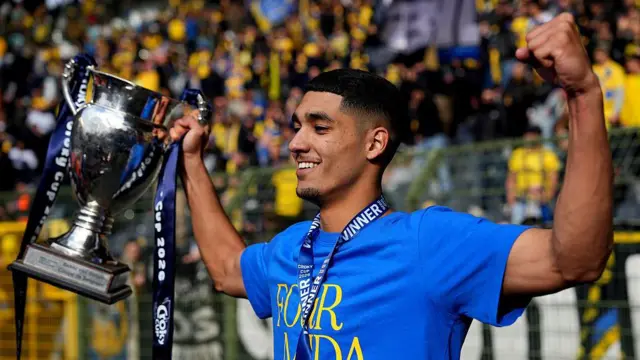 Anan Khalaili of Union Saint-Gilloise poses for a photo with the Trophy