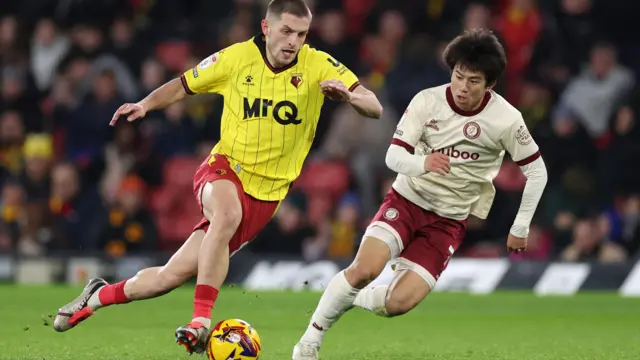 Watford's Giorgi Chakvetadze runs with the ball past Yu Hirakawa of Bristol City