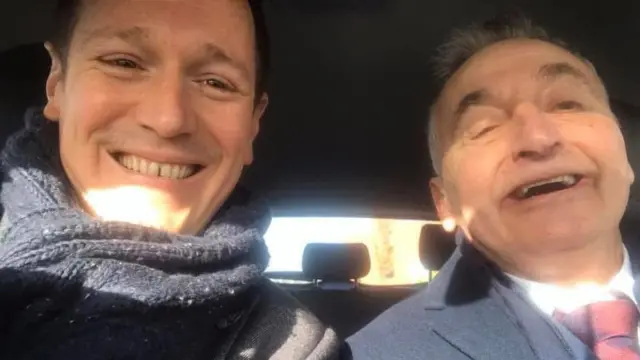 A photo of Andy Bayes (left) and Tony Parkes (right) smiling into the camera inside a car