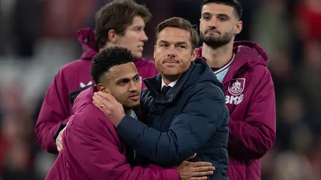 Marcus Edwards and Scott Parker embrace at full time with two Burnley players in the background