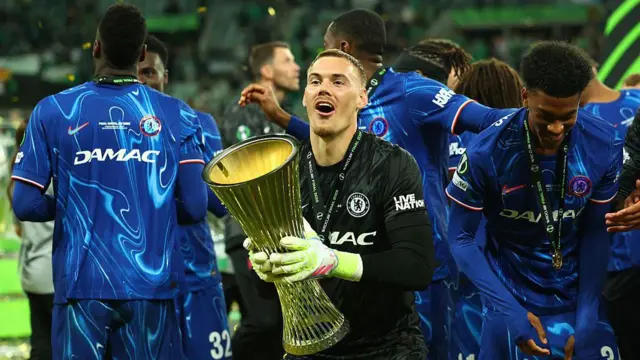 Filip Jorgensen of Chelsea celebrates with the Conference League trophy